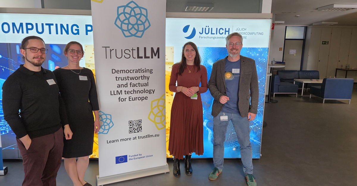 Four members of the TrustLLM consortium in front of a TrustLLM roll-up.